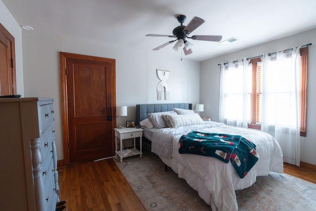 bedroom featuring ceiling fan and dark hardwood / wood-style flooring