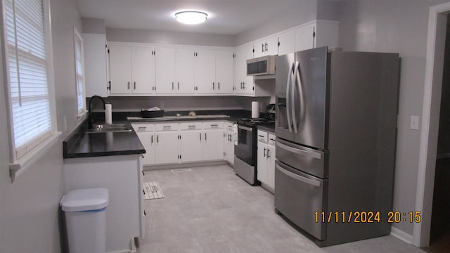 kitchen featuring sink, white cabinets, and appliances with stainless steel finishes