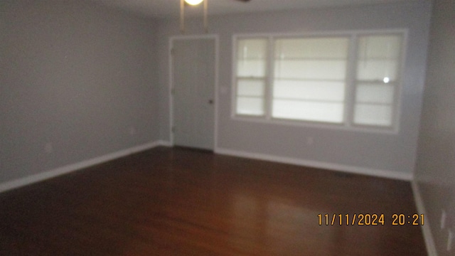 spare room featuring wood-type flooring and ceiling fan