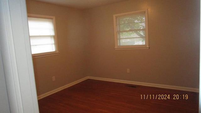 empty room with dark wood-type flooring