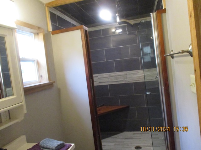 bathroom with a shower with shower door