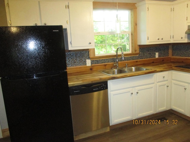 kitchen featuring white cabinets, black refrigerator, sink, stainless steel dishwasher, and decorative light fixtures