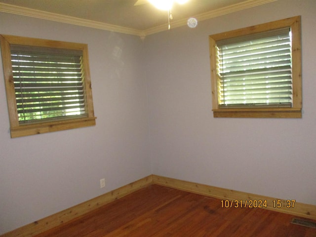 unfurnished room with wood-type flooring and ornamental molding