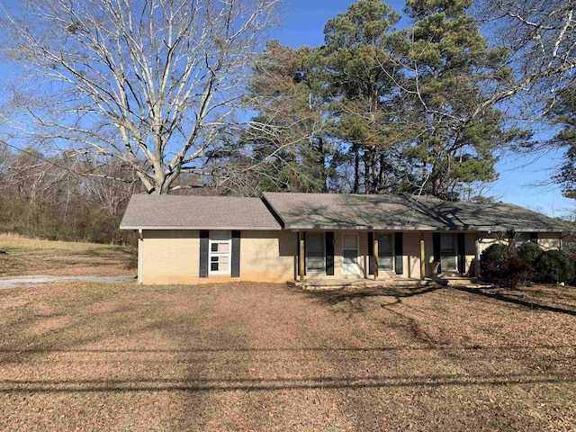 ranch-style house with a front lawn and covered porch