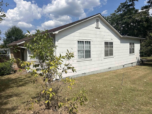 view of home's exterior with a yard