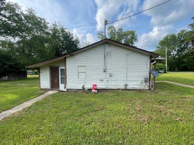  - back of property with a lawn