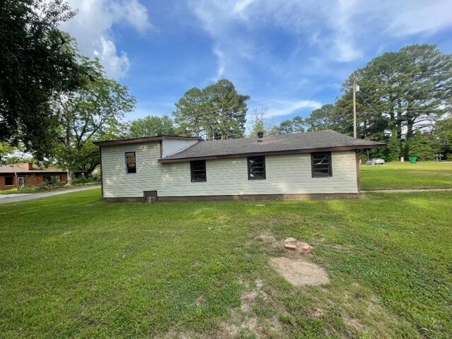  - rear view of house featuring a lawn