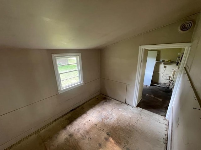  - spare room featuring vaulted ceiling