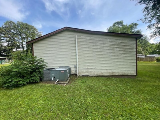 - view of home's exterior with a cooling unit and a lawn