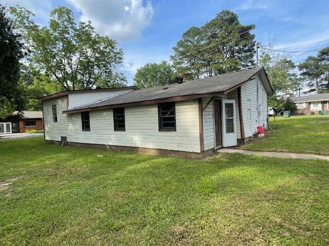  - view of side of home featuring a lawn