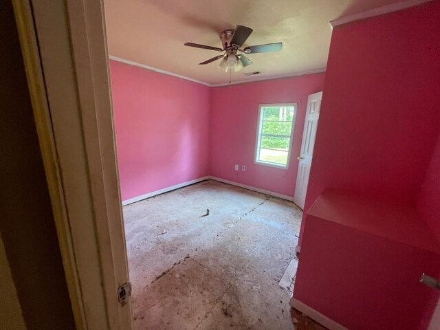  - empty room featuring a ceiling fan and crown molding