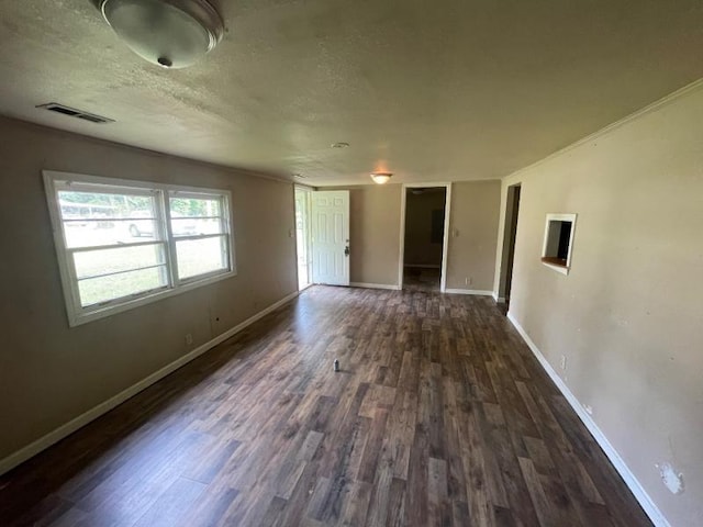  - spare room featuring dark wood-style flooring and a textured ceiling