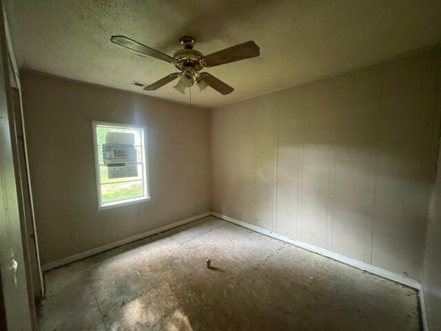  - spare room featuring a ceiling fan and baseboards