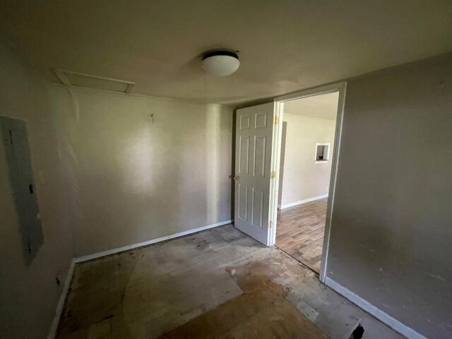  - empty room with baseboards and attic access