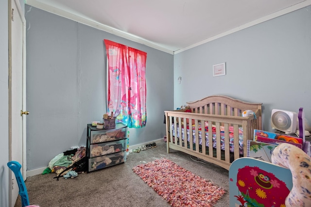 - carpeted bedroom with a nursery area, baseboards, and ornamental molding