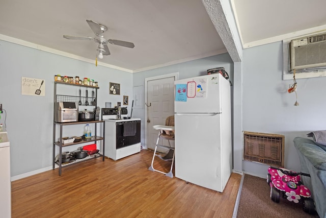  - kitchen featuring white appliances, a ceiling fan, wood finished floors, a wall mounted AC, and ornamental molding