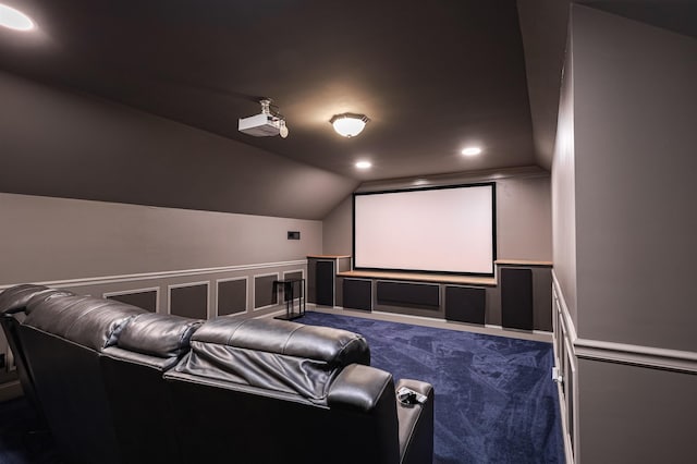 home theater featuring wainscoting, carpet, vaulted ceiling, a decorative wall, and recessed lighting