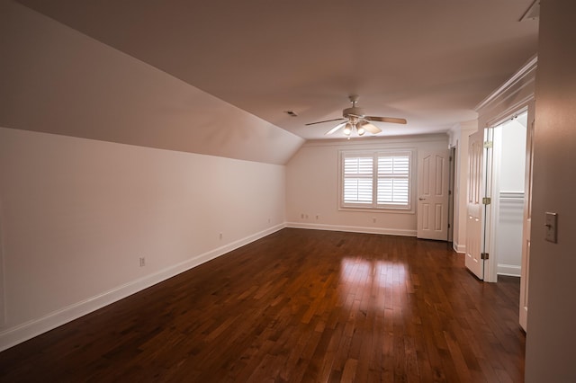 additional living space featuring a ceiling fan, dark wood-style flooring, vaulted ceiling, and baseboards