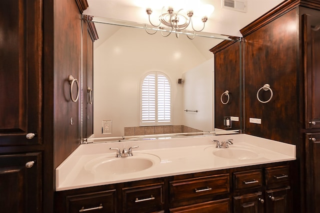 full bath featuring visible vents, a sink, a bath, and double vanity