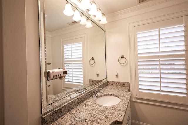 bathroom featuring visible vents, vanity, and crown molding