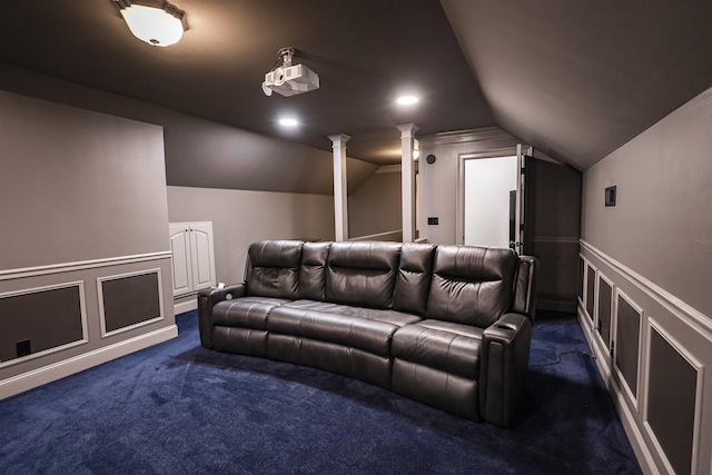 cinema room featuring a decorative wall, recessed lighting, vaulted ceiling, dark colored carpet, and ornate columns