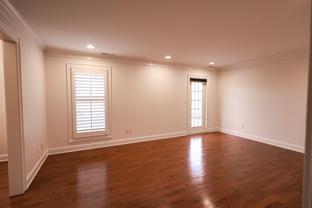 spare room with dark wood-style floors, baseboards, and crown molding