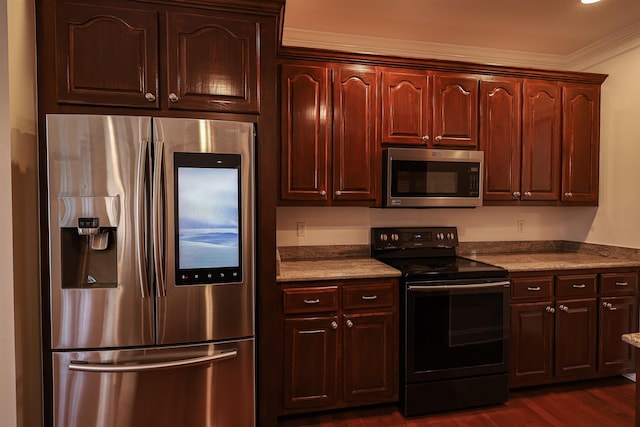 kitchen with appliances with stainless steel finishes, dark wood finished floors, and crown molding