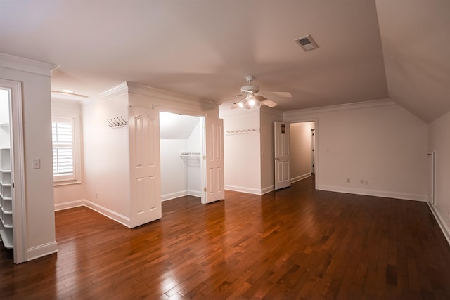 additional living space with baseboards, visible vents, dark wood finished floors, and a ceiling fan