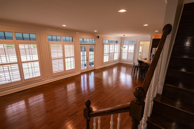 living area featuring ornamental molding, recessed lighting, visible vents, and dark wood finished floors