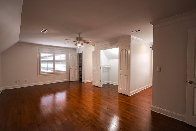 additional living space with dark wood-style floors, visible vents, baseboards, and a ceiling fan