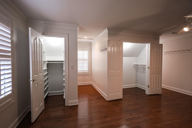 interior space with ornamental molding, dark wood finished floors, visible vents, and baseboards