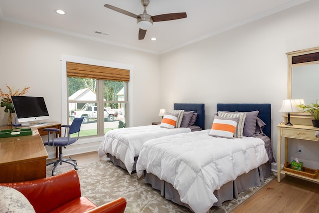 bedroom featuring ceiling fan, ornamental molding, and hardwood / wood-style floors