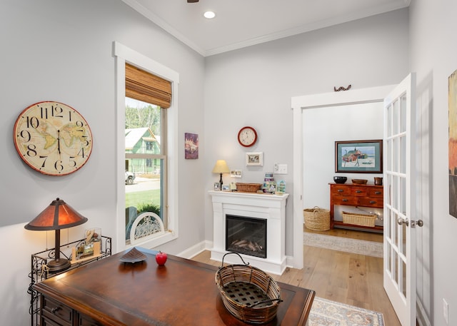 interior space featuring ornamental molding, light wood-type flooring, and french doors