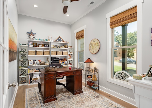 home office featuring light hardwood / wood-style flooring, ornamental molding, and ceiling fan