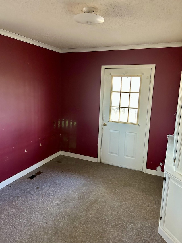 entryway featuring visible vents, carpet flooring, a textured ceiling, and crown molding