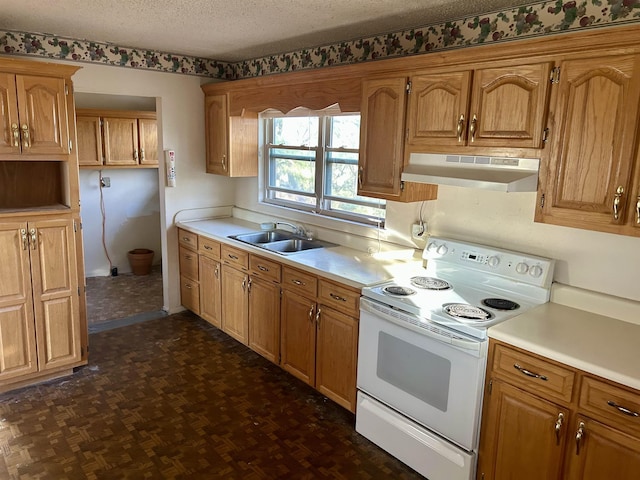 kitchen featuring under cabinet range hood, white electric range, a sink, a textured ceiling, and light countertops