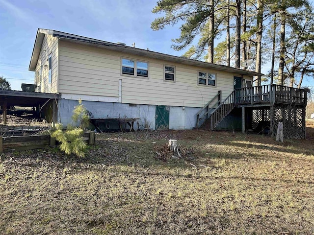 back of property with stairs, a deck, and crawl space