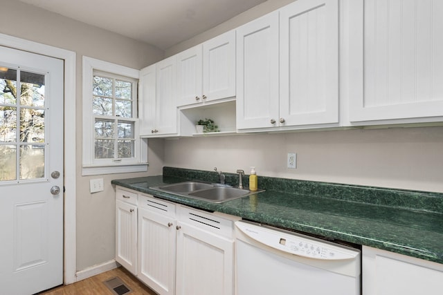 kitchen with sink, hardwood / wood-style floors, white cabinets, and white dishwasher