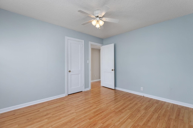 unfurnished room featuring a textured ceiling, light hardwood / wood-style flooring, and ceiling fan