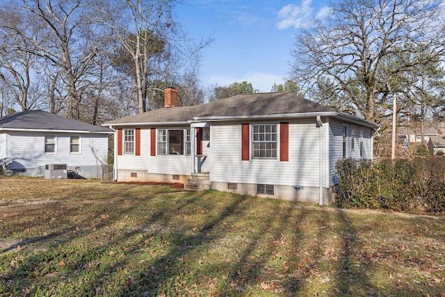 view of front of home with a front yard and central AC unit