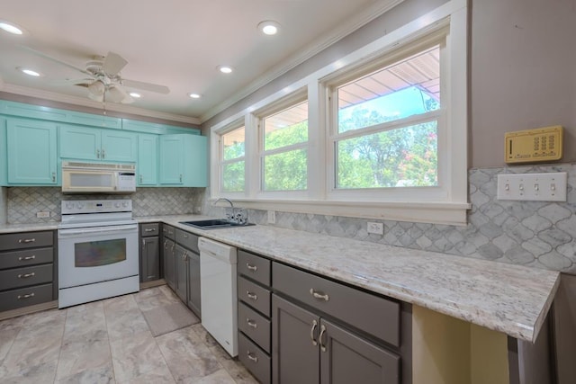 kitchen featuring white appliances, backsplash, crown molding, sink, and ceiling fan