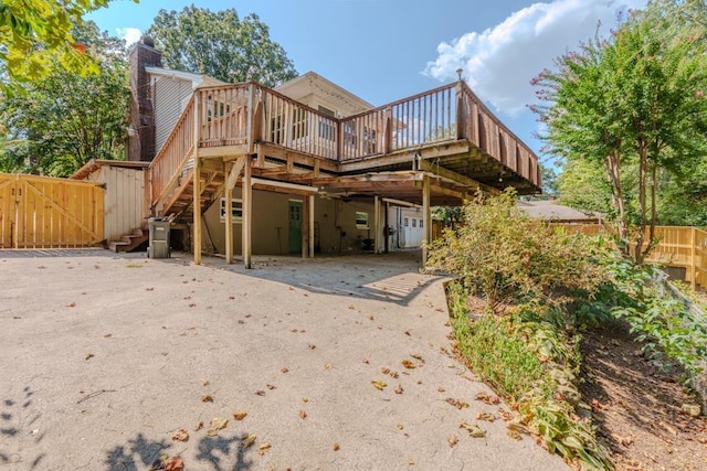 rear view of house with a wooden deck