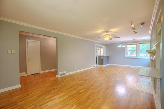 unfurnished living room with track lighting, light wood-type flooring, ceiling fan with notable chandelier, and ornamental molding