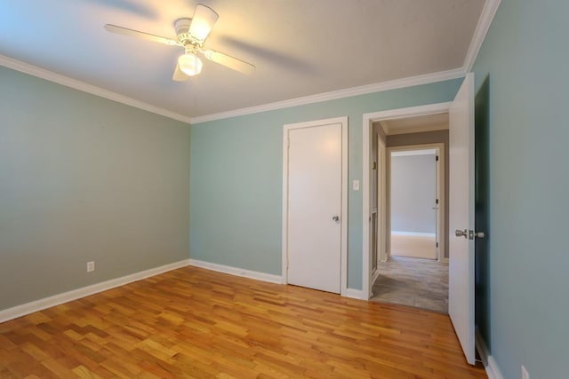 unfurnished bedroom featuring ceiling fan, crown molding, and light hardwood / wood-style flooring