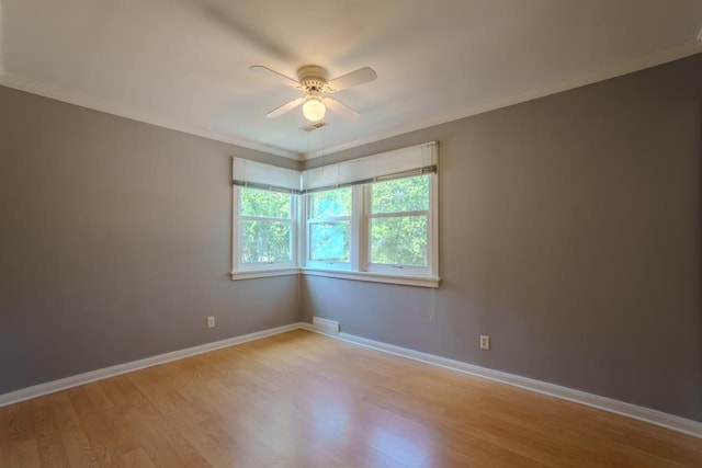 empty room featuring ceiling fan, light hardwood / wood-style flooring, and crown molding