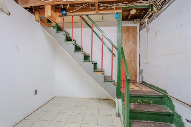 staircase featuring tile patterned floors