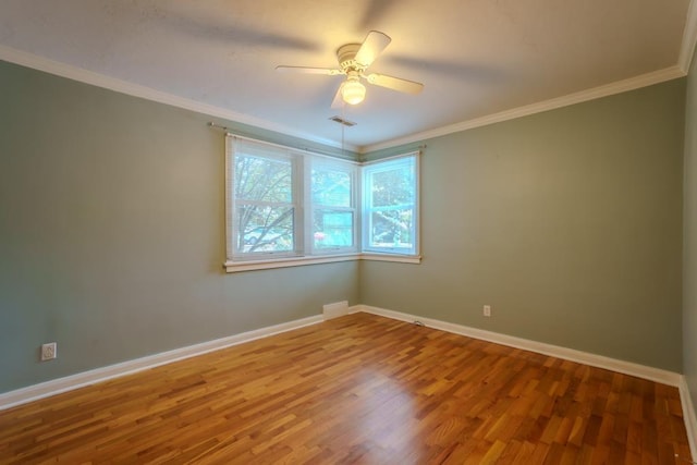 unfurnished room featuring ceiling fan, ornamental molding, and hardwood / wood-style flooring