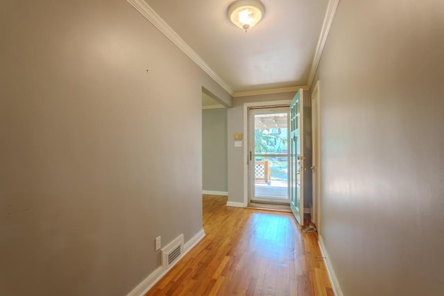 entryway featuring crown molding and light hardwood / wood-style flooring