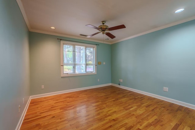 spare room featuring light hardwood / wood-style floors, ceiling fan, and crown molding