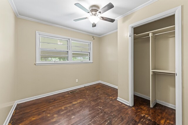  - unfurnished bedroom featuring dark wood finished floors, a closet, ornamental molding, and a ceiling fan